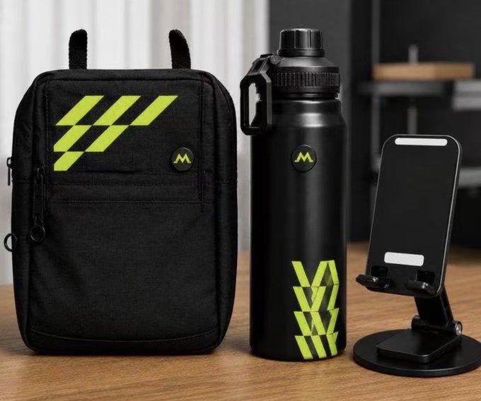 A product photo of a black and neon green accessory bundle including a backpack, water bottle, and phone stand, all branded with a stylized 'M' logo.