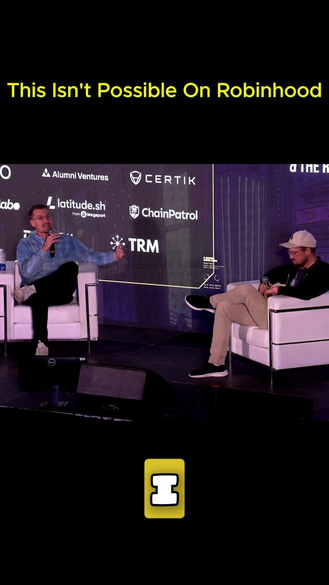 The image features two men sitting in chairs, with one man speaking into a microphone while the other listens attentively. The background includes a banner displaying logos for various companies such as "ChainserLite", "Coinbase", and "Intrinsic". The caption of the image reads "This isn't possible on Robinhood" followed by an explanation about the post's content, which is related to cryptocurrency or stock trading platforms.