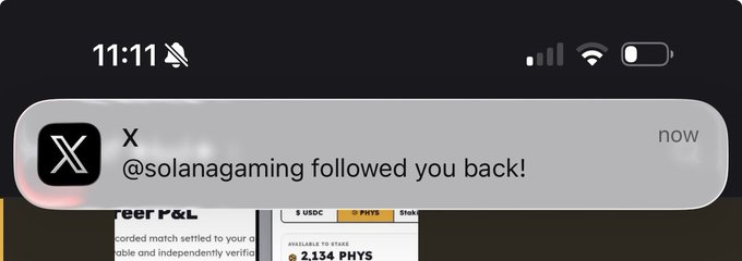 A mobile notification from X shows that @solanagaming followed the user back, displayed at 11:11 with a muted sound icon. In the background, a partially visible chart shows "2.134 PHYS" as available to stake, suggesting the notification aligns with the post's optimistic tone about their project's momentum and growing engagement.
