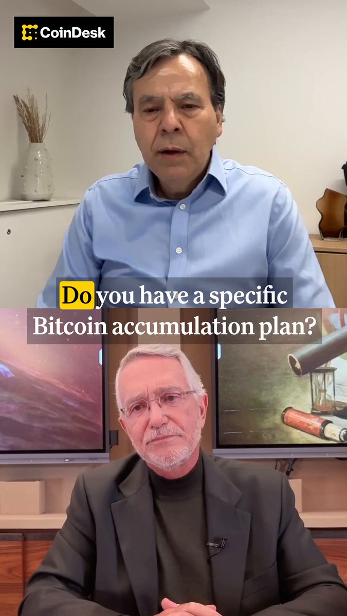The image shows two men sitting at a table with a TV screen behind them. One man has his arms crossed while the other one is seated comfortably. The TV screen displays an advertisement for Bitcoin, which includes text that reads "Do you have a specific Bitcoin accumulation plan?" and "As soon as I get my hands on some fiat, I turn it into Bitcoin."
