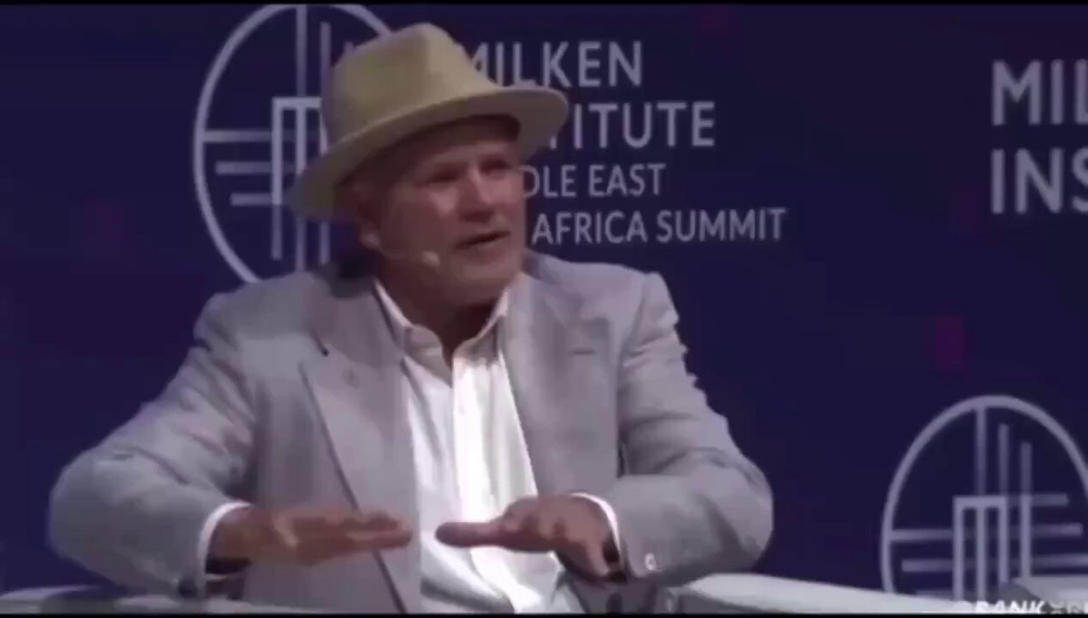 The image shows a man wearing a hat, sitting at a table with his hands together. The caption of the image reads "Milken Institute Africa Summit", which suggests that this event might be related to the African continent or the Milken Institute itself. The caption also mentions an announcement made by major banks on May 4th, indicating some sort of financial news or development in the area.