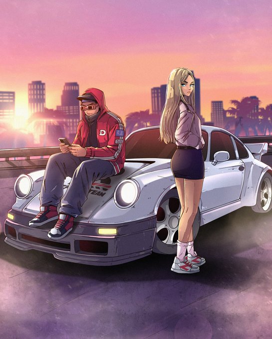 The image features two people sitting next to a white sports car with an electric motor, parked on the side of a road. One person appears to be using a cell phone while the other stands nearby. A car dealership sign can also be seen in the background.