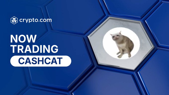 A promotional banner from crypto.com announcing that CashCat ($CASHCAT) is "NOW TRADING," featuring the Crypto.com logo and a cat image on a blue hexagonal background, illustrating the meme coin's new centralized exchange listing highlighted in the post.
