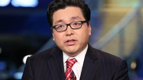 A man in a dark pinstripe suit, white shirt, and red striped tie with black-rimmed glasses appears to be speaking in a news broadcast setting. The image likely relates to the breaking news about BitMine (비트마인), an Ethereum-related entity mentioned in the caption that has surpassed 5.8 million ETH holdings.