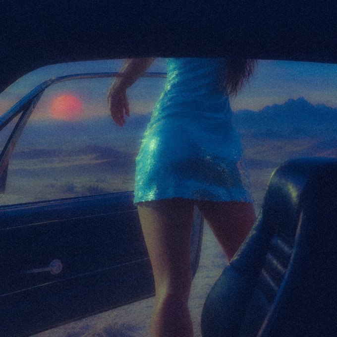 An atmospheric painting depicting a person in a sparkly teal dress stepping out of a car, viewed from inside the vehicle against a dusky sunset sky.