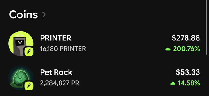 A cryptocurrency price listing shows PRINTER at $278.88 with a 200.76% increase and Pet Rock at $53.33 with a 14.58% increase, both with green up arrows.