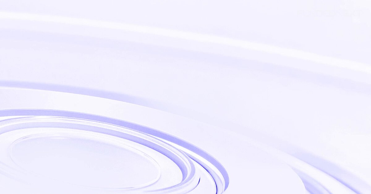 The image shows a circular design with blue lines that creates a sense of movement, resembling waves or ripples. The background appears to be gray. The caption underneath reads, "If you've been delaying getting a FundedNext account because of the 5 minimum trading days requirement... You just lost your excuse. FundedNext has reduced it from 5 days to just 2 days on Stellar 2-Step and Stellar Lite accounts. Less waiting. Faster progression."