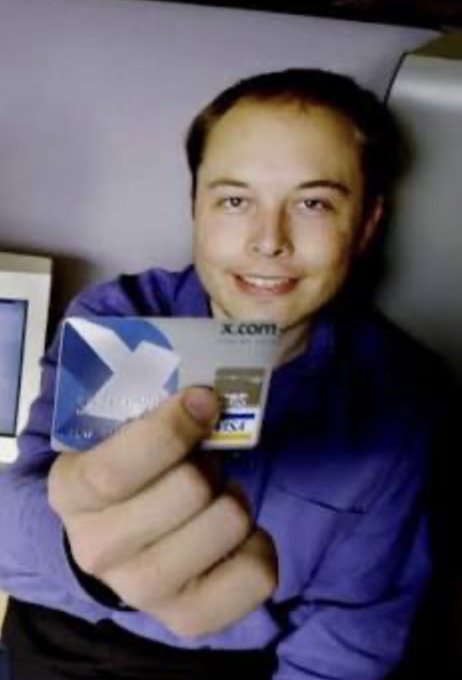A man holds up an X.com debit card toward the camera, matching the post's excited announcement about being approved for X Money.