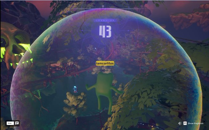 A video game screenshot showing a green character inside a large iridescent bubble in a forest setting, with the number "43" displayed and the username "iamcarlitos".