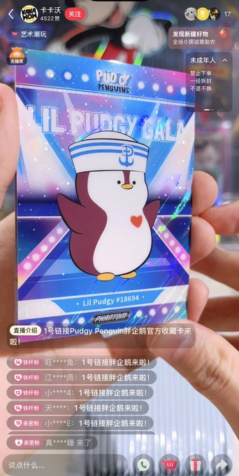 This image shows a holographic collectible card featuring "Lil Pudgy #18694" from Pudgy Penguins, marking their official entry into the Chinese collectible card market with a collaboration with Kakawow. The card has a sailor-themed penguin graphic and the text "Lil Pudgy GALA" and "PHANTOM."