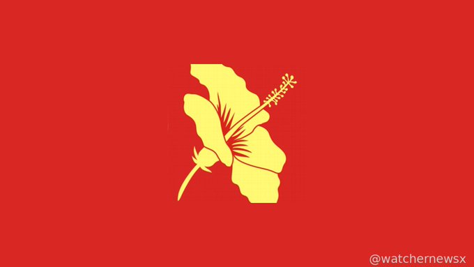 A red flag featuring a yellow hibiscus flower emblem with a bud and leaf, credited to @watchernewsx in the bottom right corner.