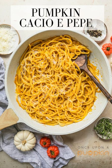 A skillet of pumpkin cacio e pepe pasta is displayed with the title "PUMPKIN CACIO E PEPE" and the "Once Upon a Pumpkin" brand logo, surrounded by small pumpkins, tomatoes, grated cheese, and peppercorns—fitting the "It's uptober loser" autumn-themed caption by celebrating a seasonal pumpkin twist on the classic Italian dish.