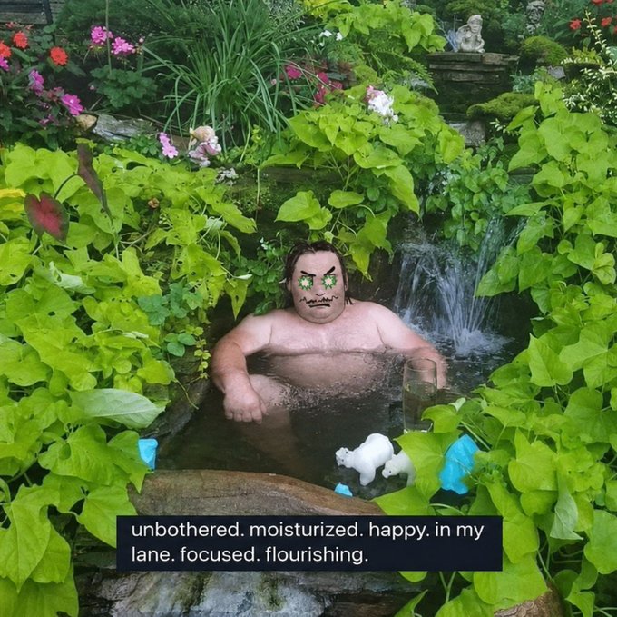 A digitally edited image shows a man soaking in a garden hot tub surrounded by lush greenery and flowers, with a cartoonish angry face pasted over his real features and small plush toys floating in the water. The meme caption reads "unbothered. moisturized. happy. in my lane. focused. flourishing." — used to mockingly taunt those who sold a "Collective BTC" Fragment at .0015 just before the floor price rose 5x, framing the poster as thriving while others suffer losses.