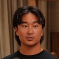 A man with short dark hair wearing a black shirt looks directly at the camera with a neutral expression, representing "Orangie" who mentioned investing a significant portion of his net worth into FOMO at a $550M valuation.