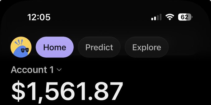 The image shows a mobile app screen displaying an account balance of $1,561.87, with the "Home" tab selected and navigation options for "Predict" and "Explore." The interface resembles a cryptocurrency or prediction platform, which aligns with the post's announcement of an airdrop giveaway where participants can win crypto-related rewards.
