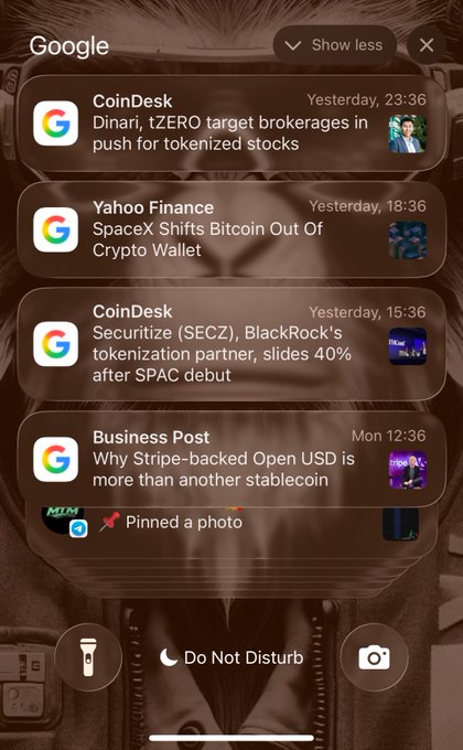 A Google notifications screen displaying crypto news headlines from CoinDesk, Yahoo Finance, and Business Post, including "Dinari, tZERO target brokerages in push for tokenized stocks" and "SpaceX Shifts Bitcoin Out Of Crypto Wallet."