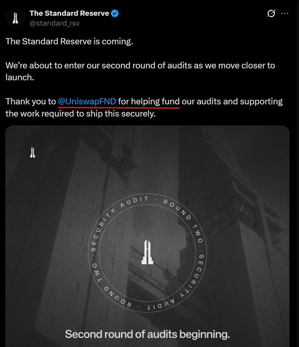 A Twitter post from @standard_rsv announces "The Standard Reserve is coming," highlighting that the project is entering its second round of security audits ahead of launch, and thanks @UniswapFND for funding the audits. The accompanying graphic features a dark architectural image with a circular emblem reading "SECURITY AUDIT • ROUND TWO • SECURITY AUDIT • ROUND TWO" and the caption "Second round of audits beginning."