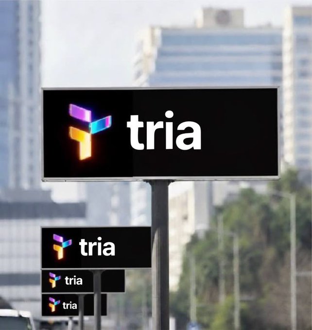 The image features a billboard with the word "TRIA" written on it. The billboard also has a logo that says "Focus on what is in the image and how it relates to the post." This suggests that the focus of the image should be on the content displayed on the billboard, rather than on unrelated details or distractions around it.