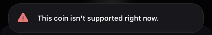 Dark-themed error notification banner with a red warning triangle icon displaying the message 'This coin isn't supported right now.'