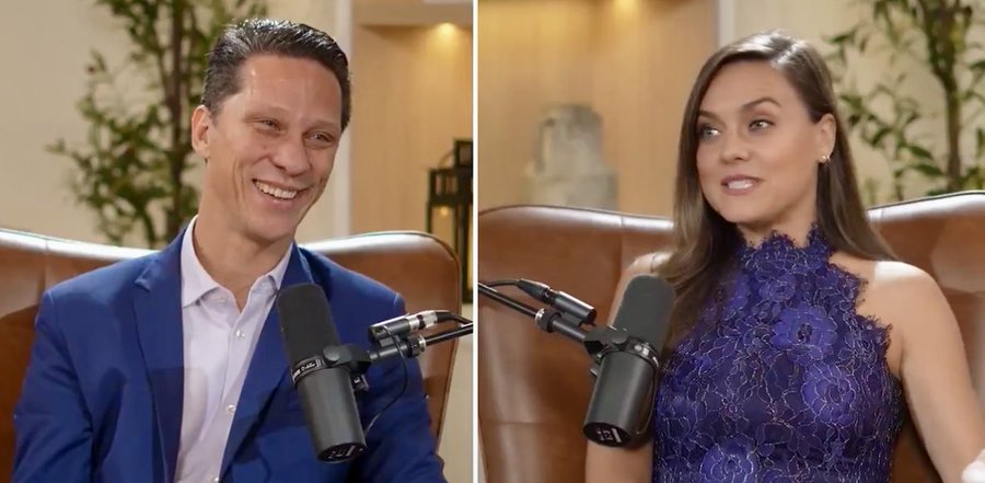 The image shows a split-screen view of two people in what appears to be a podcast or interview setting, each seated in front of microphones in leather chairs. On the left is a man in a blue suit and white shirt, smiling broadly, while on the right is a woman with long dark hair wearing an elegant purple lace top. The warm, modern studio setting with decorative plants in the background suggests a professional podcast or talk show environment. This aligns with the post's reference to Natalie Brunell's show, as the image likely depicts the woman on the right as Brunell during a podcast episode, connecting the discussion about "value extraction" to her content focused on Bitcoin and economics.