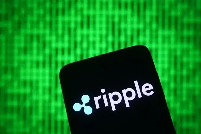 A smartphone displaying the Ripple logo and name against a green, matrix-style digital background.