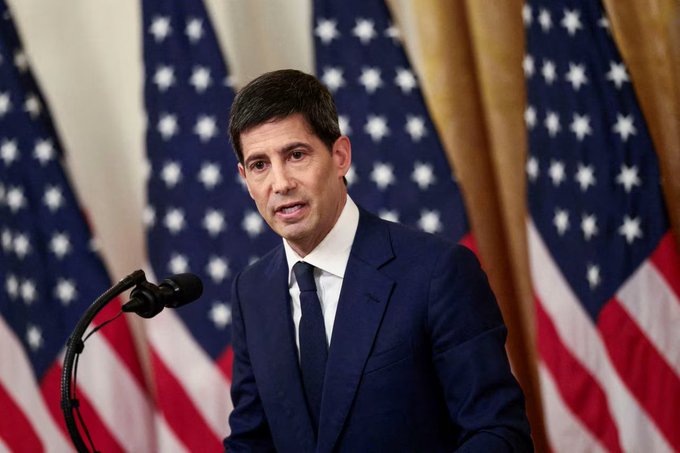 The image shows a man wearing a suit, speaking into a microphone at a podium with an American flag behind him. The caption reads "$BTC Decision time. Forget the headline number. Watch Kevin Warsh' s tone in the press conference - that's what actually moves this market." This suggests that the man is addressing an important issue or making a significant announcement related to the economy, and he wants his words to have a strong impact on the public. The use of the hashtag #FOMC indicates that the post might be about a recent decision made by the Federal Reserve Bank of America (FED) regarding monetary policy.