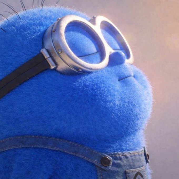 The image features a blue, furry character with goggles and an overalls outfit, possibly from the movie "Despicable Me". The character appears to be looking off into space or daydreaming while wearing the goggles. The caption below the image reads: "Trust the process...". This message encourages viewers to trust their own creative process when working on a project like making a movie or creating art.