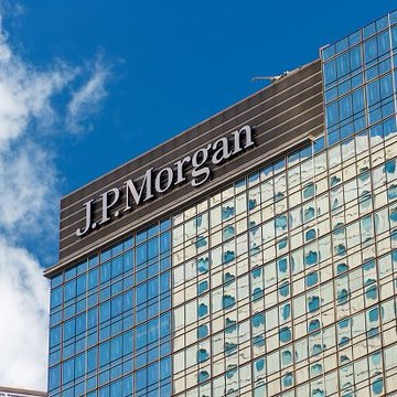 The JPMorgan Chase & Co. office tower prominently displays the company's "J.P.Morgan" logo on its glass facade, matching the institutional banking firm behind the newly announced JPM Coin deposit token launch on Ethereum, which will enable round-the-clock, near-instant settlement for corporate clients.