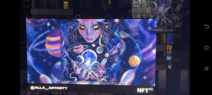 A digital art display shows a cosmic-themed illustration of a person holding planets in their hands. Text reads '@ALLA_ARTASTY' and 'NFT' with various UI elements visible.