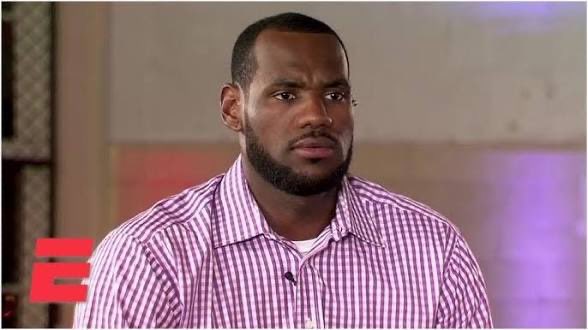 LeBron James appears in an ESPN interview wearing a pink and white checkered shirt.