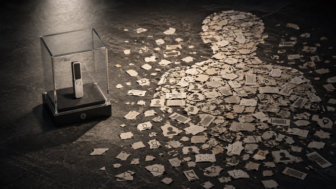 A glass display case containing a small device sits beside a silhouette of a person composed entirely of fragmented personal data cards bearing barcodes, user icons, and contact symbols, visually representing how an individual's identity is scattered across exposed records. The image illustrates the post's message that crypto security often overlooks the vulnerability of personal information—names, emails, phone numbers, and shipping addresses—rather than the seed phrase itself.