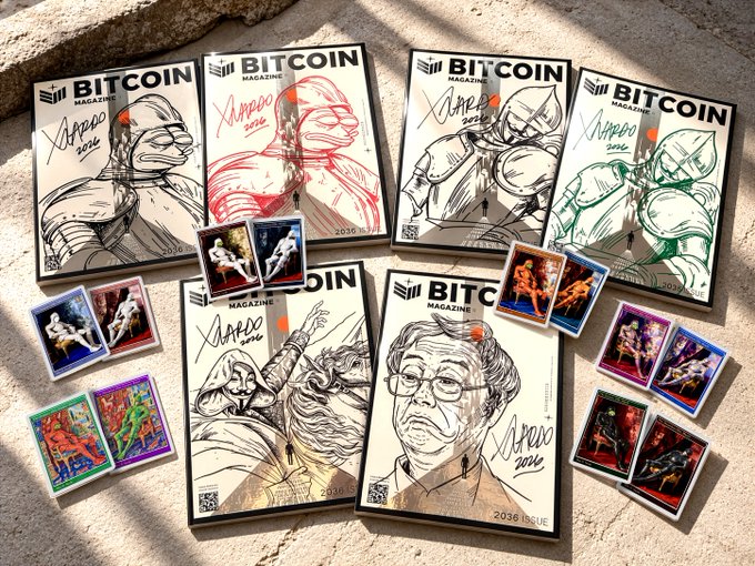 Bitcoin Magazine covers and collectible-style cards are arranged on a stone surface, featuring “BITCOIN MAGAZINE” branding and illustrated superhero-like figures including a Bitcoin logo.