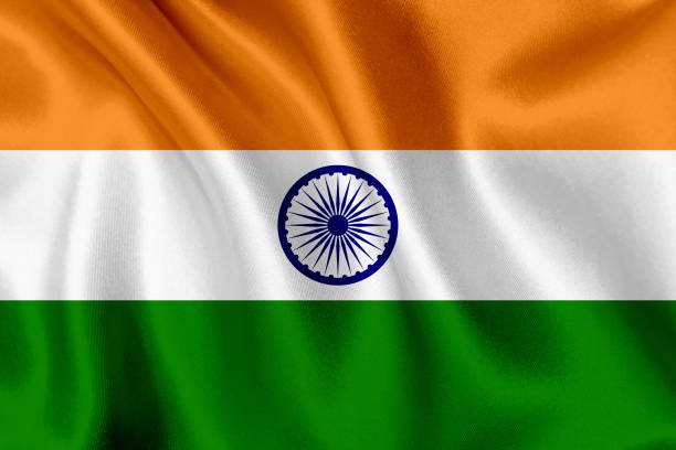 The image shows the flag of India, featuring saffron, white, and green horizontal stripes with the blue Ashoka Chakra in the center, depicted waving against a backdrop. It relates to the post by representing India, whose central bank (RBI) is pushing for a cryptocurrency ban to protect financial stability.