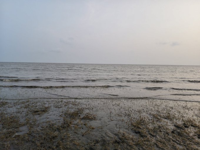 The image shows a beach scene with a calm ocean view under an overcast sky. The water appears dark grey, suggesting that it might be cloudy or during a stormy day. There are no people visible in the photo, which adds to the serene atmosphere of the scene. The image is related to the post because it features a caption about "Good morning X creator'S", which could potentially be a reference to the creator of the image or an account associated with the post.