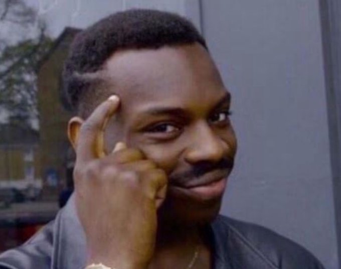A meme image of a man pointing to his temple with a knowing smile, commonly used as a 'big brain' reaction image.
