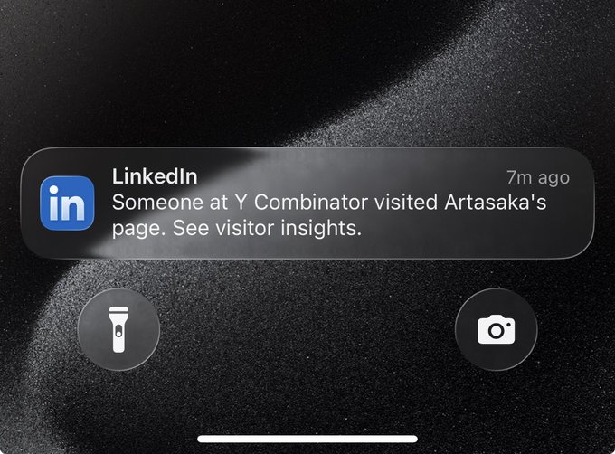 A smartphone notification screen displaying a LinkedIn alert: 'Someone at Y Combinator visited Artasaka's page. See visitor insights.'