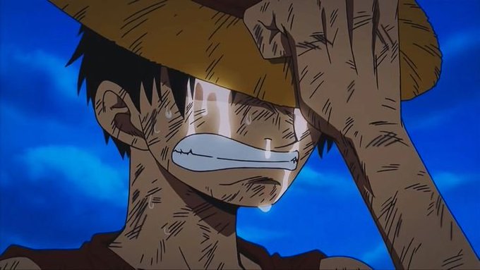 An animated character from One Piece (Luffy) wearing his straw hat, visibly sweating and looking strained against a blue sky.