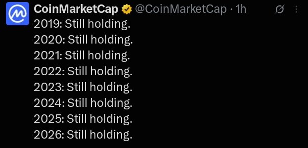 A screenshot of a tweet from CoinMarketCap (@CoinMarketCap) with a verified checkmark, reading '2019: Still holding. 2020: Still holding. 2021: Still holding. 2022: Still holding. 2023: Still holding. 2024: Still holding. 2025: Still holding. 2026: Still holding.'