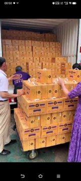 The image shows workers loading or stacking numerous yellow boxes labeled "CSCW" along with people inspecting the shipment. The accompanying post about Pi cryptocurrency describes how pioneers have spent seven years realizing Pi's practical value in circulation and real economy, and the stacked CSCW boxes symbolize tangible, physical goods being exchanged—representing the kind of real-world commerce and productivity that Pi aims to facilitate.