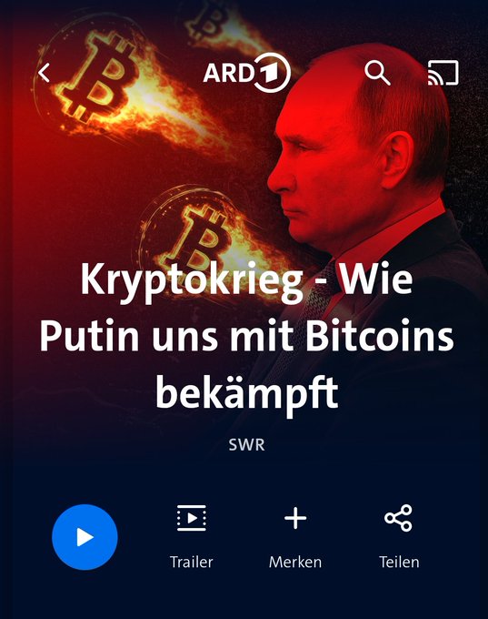 A screenshot from ARD1 shows a German documentary titled "Kryptokrieg - Wie Putin uns mit Bitcoins bekämpft" (Crypto War - How Putin fights us with Bitcoins), featuring a red-tinted image of Vladimir Putin alongside burning Bitcoin logos, with options for "Trailer," "Merken," and "Teilen." The image illustrates the post's critique that broadcaster ARD is framing Bitcoin negatively by suggesting Russia could weaponize the cryptocurrency, despite it being a neutral, globally accessible technology.