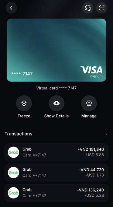 A mobile banking app screen displaying a Visa Platinum virtual card ending in 7147, with options to Freeze, Show Details, and Manage, along with recent Grab transactions in VND and USD.