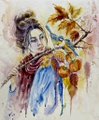 A small painted figurine or artwork depicting a figure with dark hair wearing blue and orange robes, holding a cluster of orange fruits or flowers, with autumn leaves at the top.