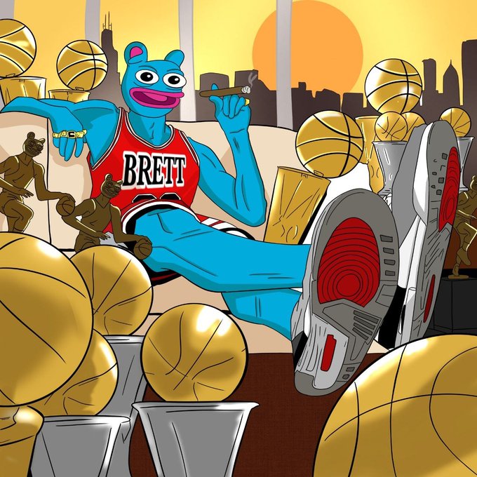 A colorful cartoon illustration of a blue bear character wearing a red 'BRETT' basketball jersey, reclining with Air Jordan sneakers amid multiple golden basketballs, trophies, and smaller bear statues against a city skyline at sunset.