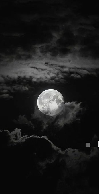 The image features a full moon with clouds above it, creating a beautiful nighttime scene. The moon appears as a bright white circle against the dark sky filled with clouds. Below the moon, there are some clouds that add depth to the overall composition of the photo. The caption below the image reads "GN CT creators How was your day, builder? Hope y’all had a great day." This message is related to the full moon and its significance in various cultures.