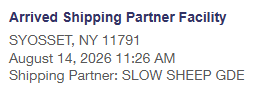 A shipping notification screenshot indicating a package has 'Arrived Shipping Partner Facility' in SYOSSET, NY 11791 on August 14, 2026 at 11:26 AM, via the 'SLOW SHEEP GDE' partner.