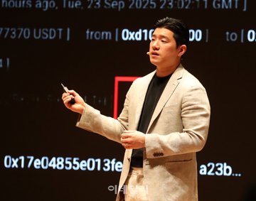 LayerZero's Head of APAC delivers a presentation, with a large screen behind him displaying cryptocurrency transaction details including "0xd1...00" and "0x17e04855e013fe...a23b..." in partial view, illustrating the on-chain activity underlying his talk about crypto shifting from infrastructure-first to problem-first thinking.