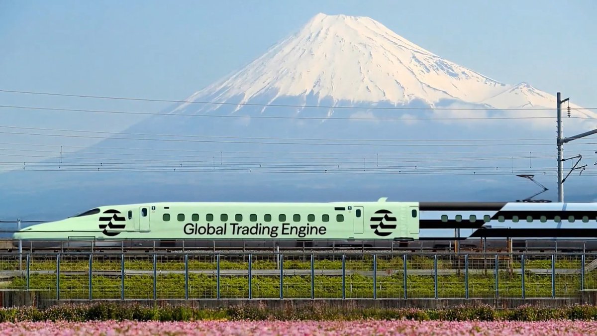 iced green bullet train, "Global Trading Engine," moves along a track with a snow-capped mountain backdrop and pink flowers on the side.