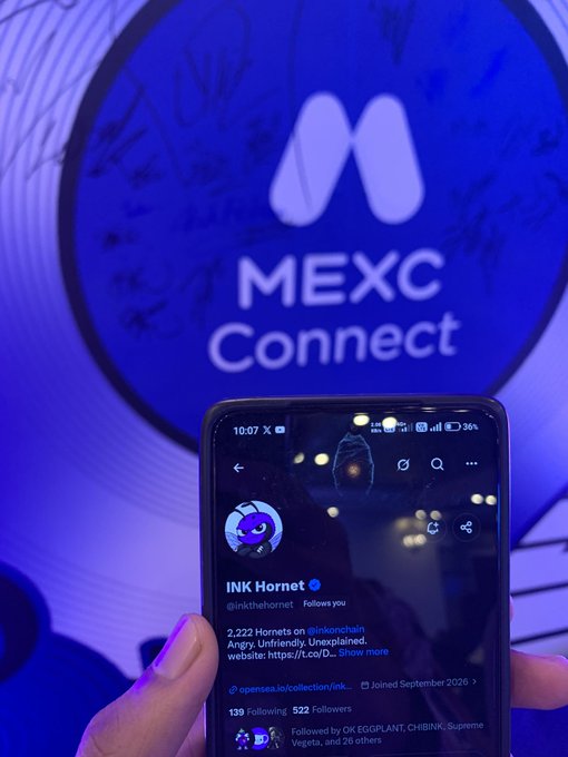A hand holds a smartphone displaying the "INK Hornet" Twitter profile (@inktothehornet) with 522 followers, in front of a blue screen showing the "MEXC Connect" logo.