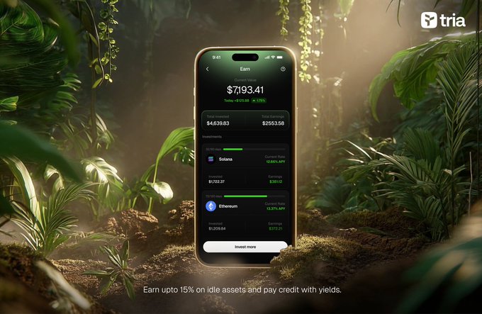 The image shows a cell phone sitting outdoors surrounded by plants and bushes. The screen displays information related to online trading services from the company @useTria, including details about earning up to 15% interest on idle assets and making payments with yields. This messaging is positioned in an aesthetically pleasing way that captures attention as it promotes these new opportunities for financial growth through online investing platforms.