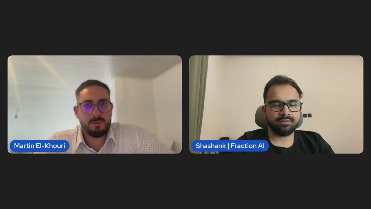 The image shows two men sitting at a desk, both wearing glasses and looking directly at the camera. They are positioned side by side with their faces close together, creating an interesting visual effect. The background of the image appears to be a computer screen or a monitor displaying some content related to the post.